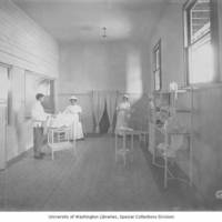 Baby_Incubator_exhibit_showing_nurses_and_a_baby_in_an_exam_room_AlaskaYukonPacificExposition_Seattle_Washington_1909.jpg